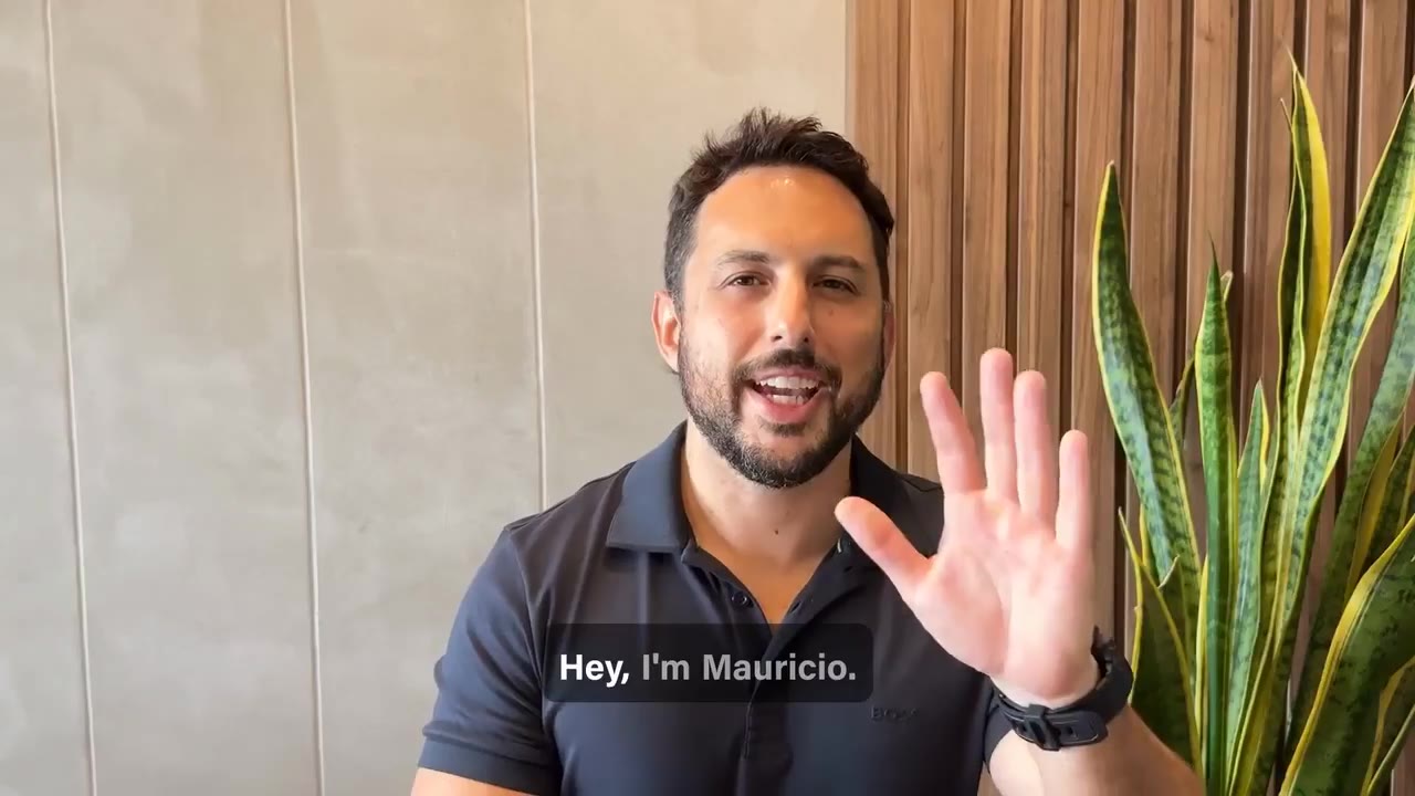 Mauricio waving at the camera at the start of his intro video